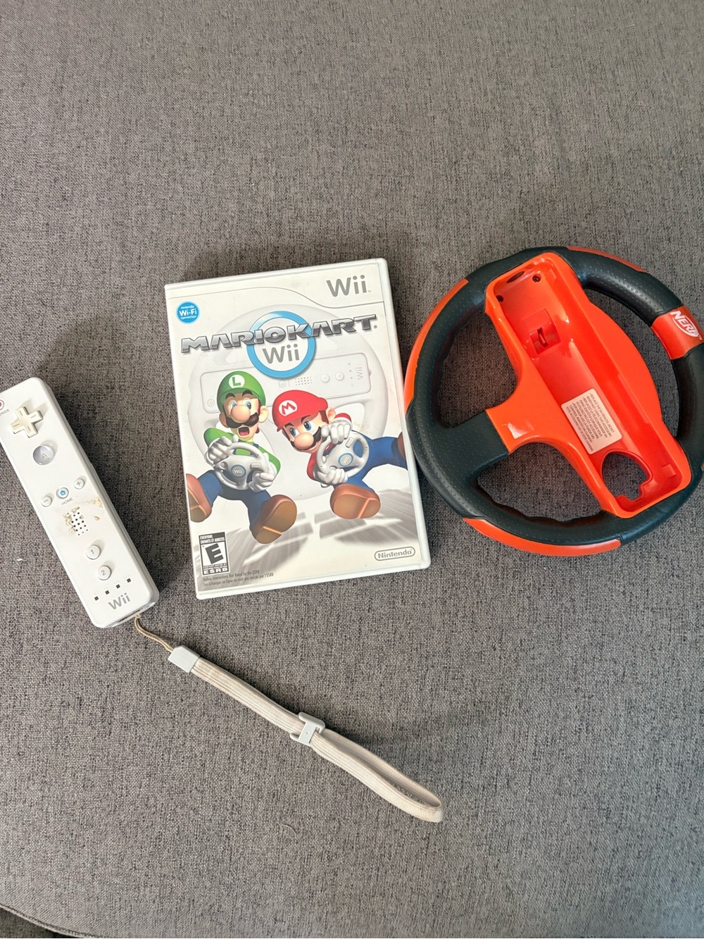 Nintendo Wii Mario Kart Game with White Wii Remote and Orange Steering Wheel